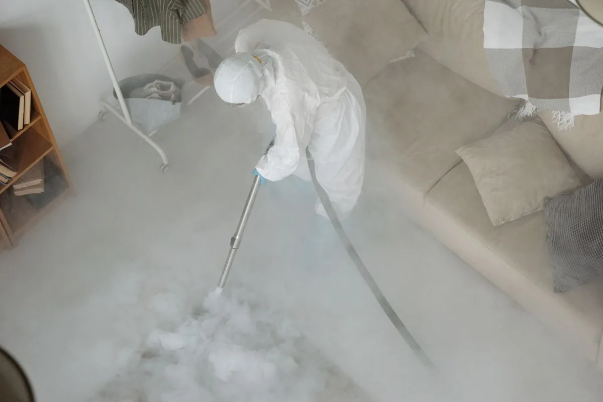 Biohazard cleanup technician in protective equipment, Ivanhoe, CA